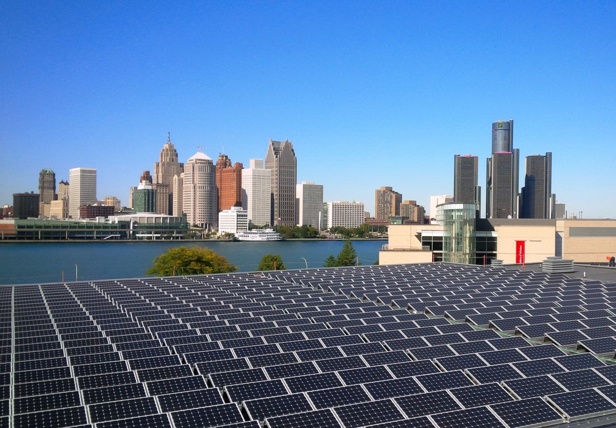 Solar array at the downtown aquatic centre, with Art Windsor-Essex, the Detroit River, and the Detroit skyline in the background
