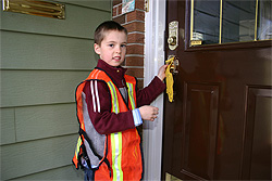 Boy hanging yellow fish hanger on a door