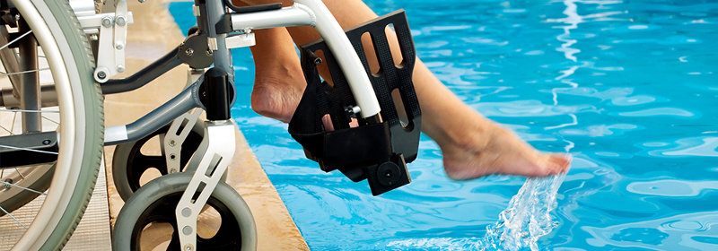 Visitor in a wheelchair getting feet wet