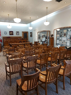 courtroom with wooden furniture and display cabinets