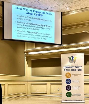 Projector screen and Community Safety and Well-Being Plan banner from Crime Prevention through Environmental Design Course