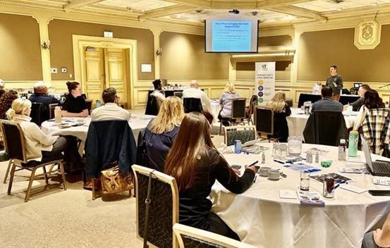 Participants sitting at tables and listening to instructor at the Crime Prevention through Environmental Design Training Course
