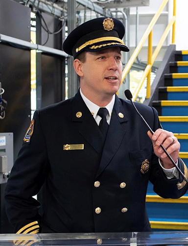 Jamie Waffle of Windsor Fire and Rescue Services in uniform at a microphone