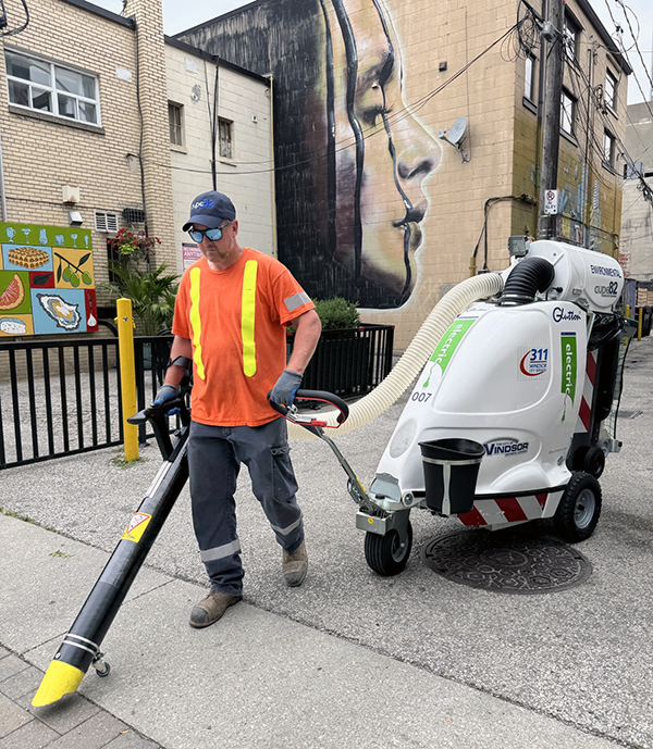 City staff member operating an electric street sweeper on Maiden Lane downtown