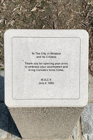 Detail of a memorial list etched into granite.