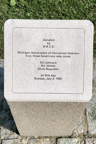 Detail of a memorial list etched into granite.