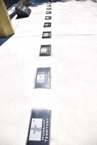 Detail of a memorial list etched into granite.