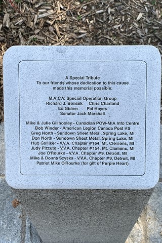 Detail of a memorial list etched into granite.