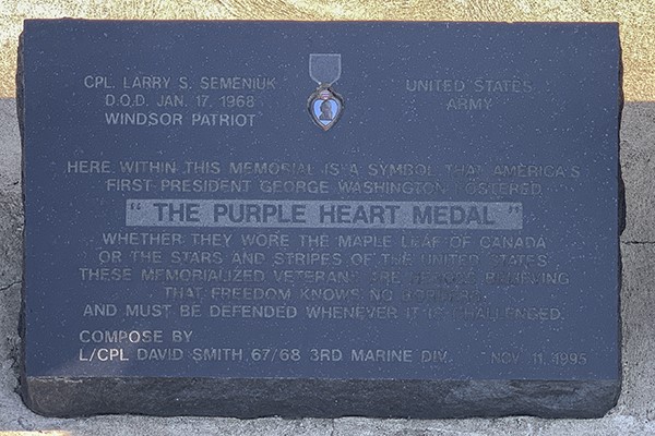 Detail of a memorial list etched into granite.