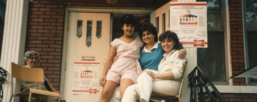 Armenian Community Windsor Historical photo of Armenian community members on the porch of the former Armenian Community Centre decorated with posters for the Carrousel of the Nations