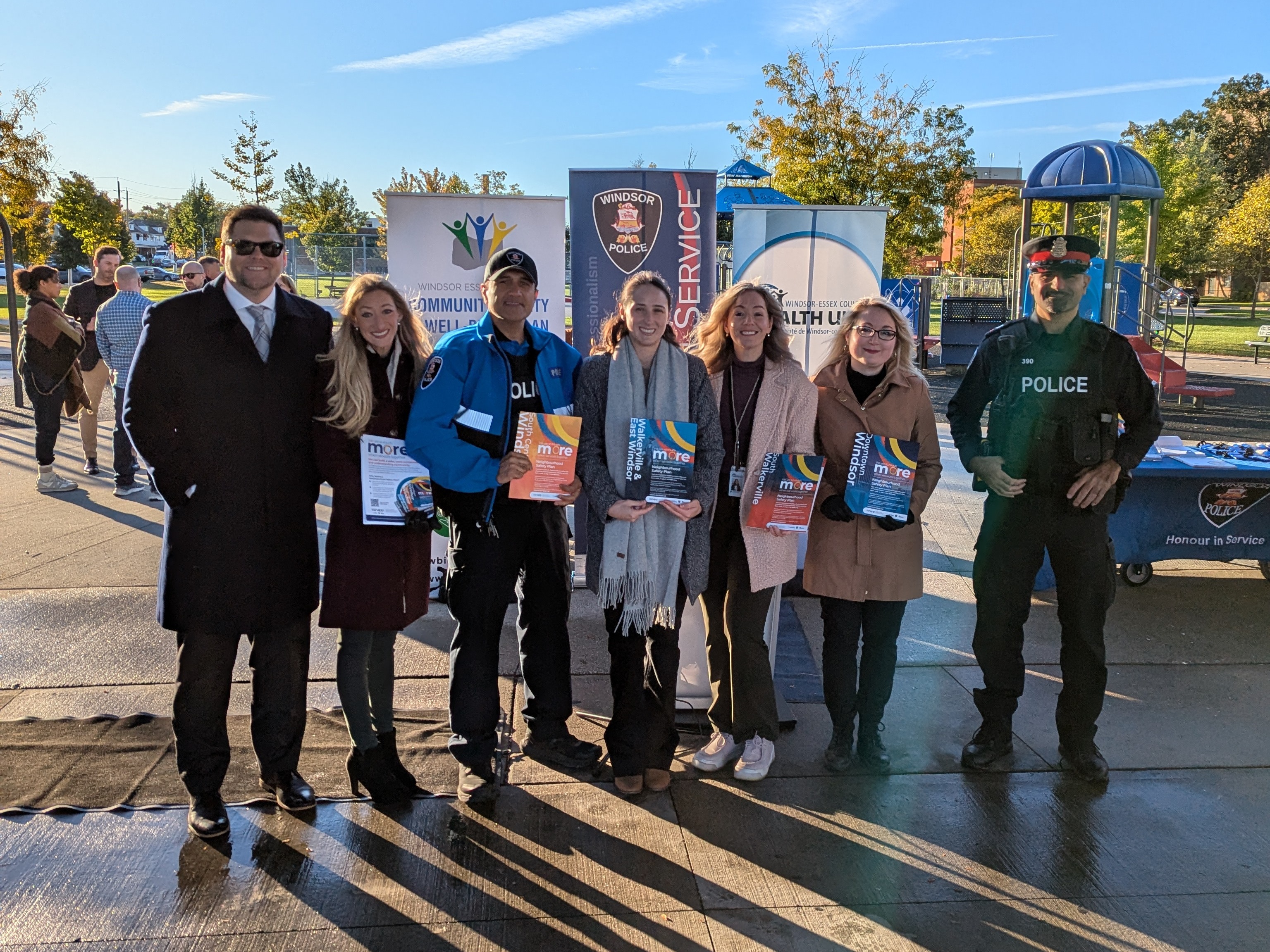 Neighbourhood Safety Plans Group Photo Representatives from the City of Windsor, Windsor Police Service, and Windsor-Essex County Health Unit holding SSNAPP Neighbourhood Safety Plans outside at a park